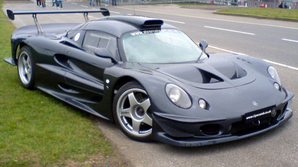 The same Lotus Elise GT1 on a circuit road, rear wing raised, www.xtremeteam.co.uk legible across the windscreen.