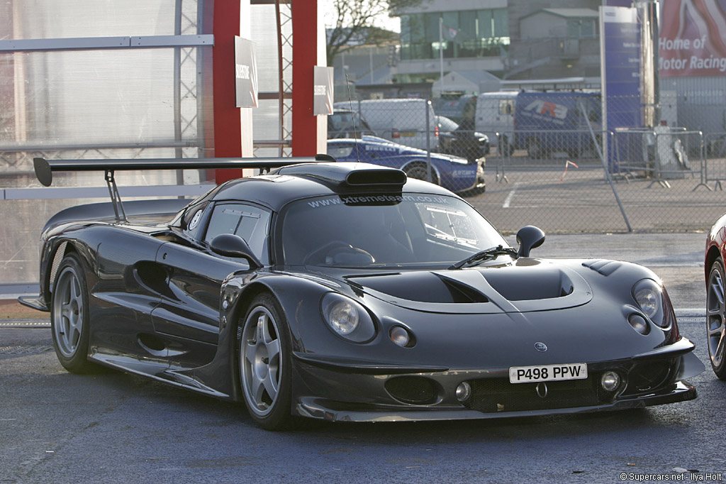 The Lotus Elise GT1 at a race circuit, rear wing up, www.xtremeteam.co.uk across the windscreen and the plate P498 PPW on the nose.